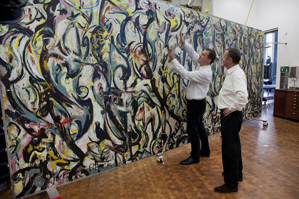 Tom Learner and Alan Phenix of the Getty Conservation Institute with Jackson Pollock's Mural