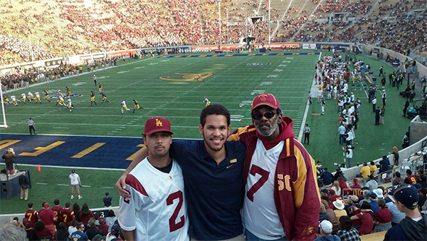 Getty intern Anthony Merrill with his father and brother at a Cal-USC game
