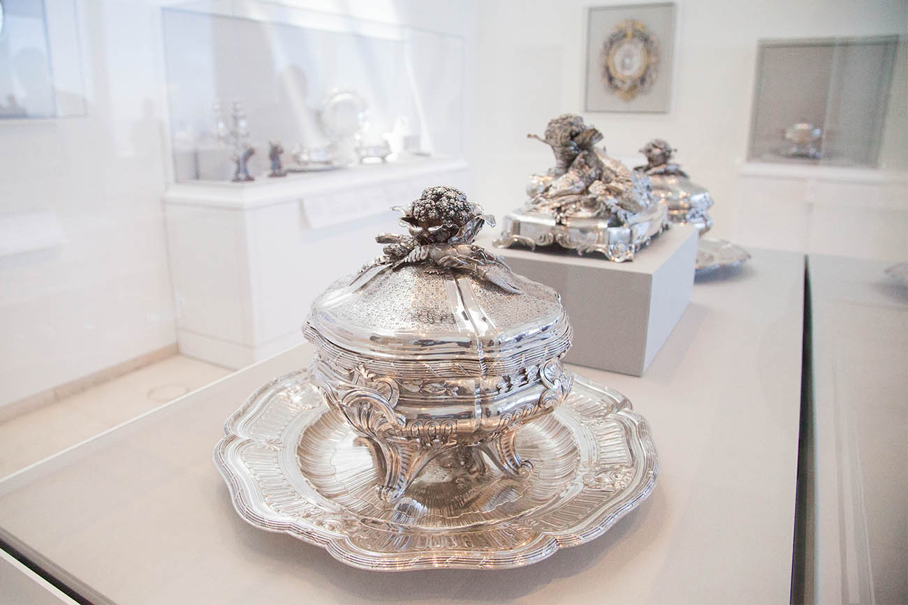 Installation shot with one of a pair of lidded tureens, liners, and stands in direct foreground.