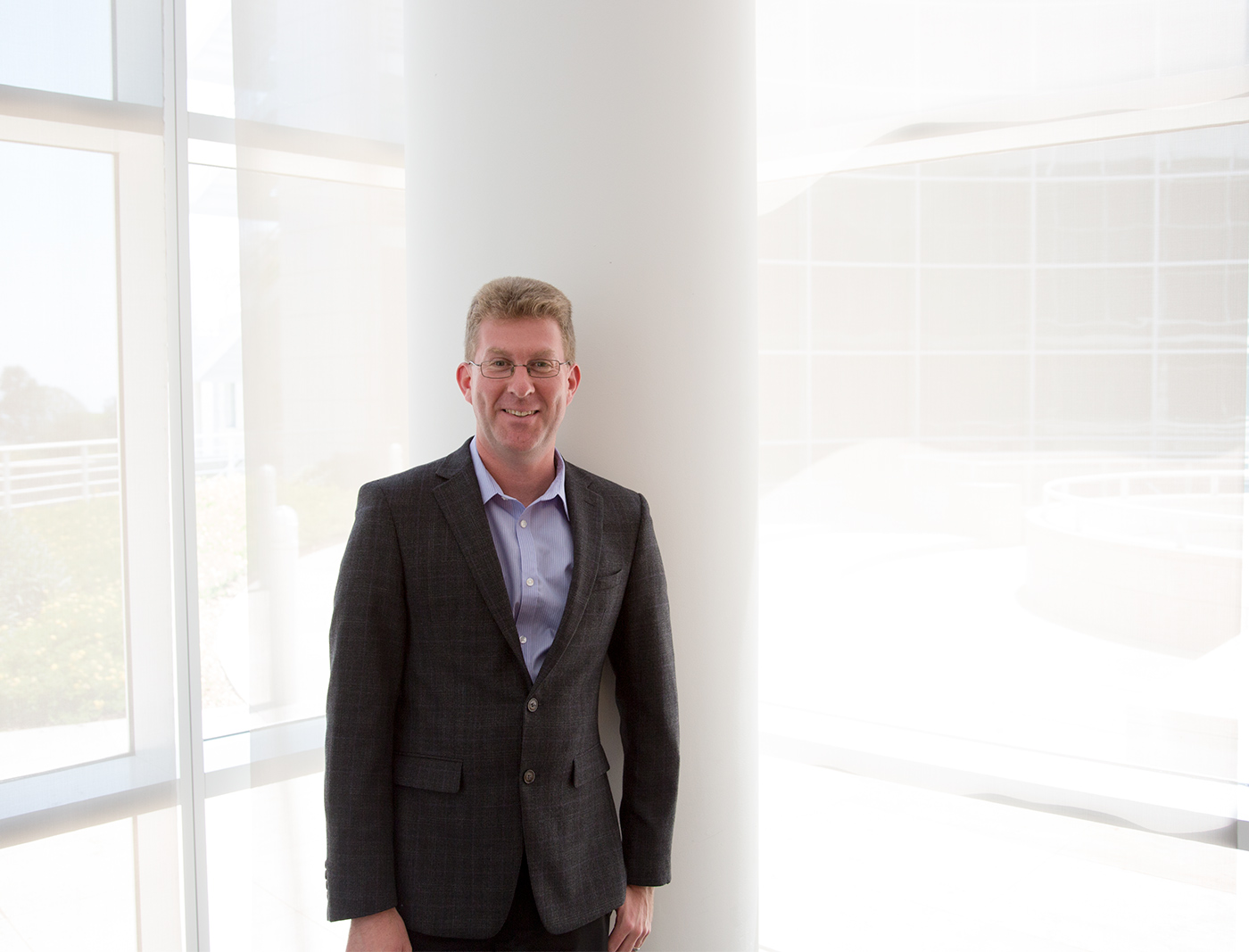 Rob Sanderson wearing a business suit and smiling inside the Getty offices