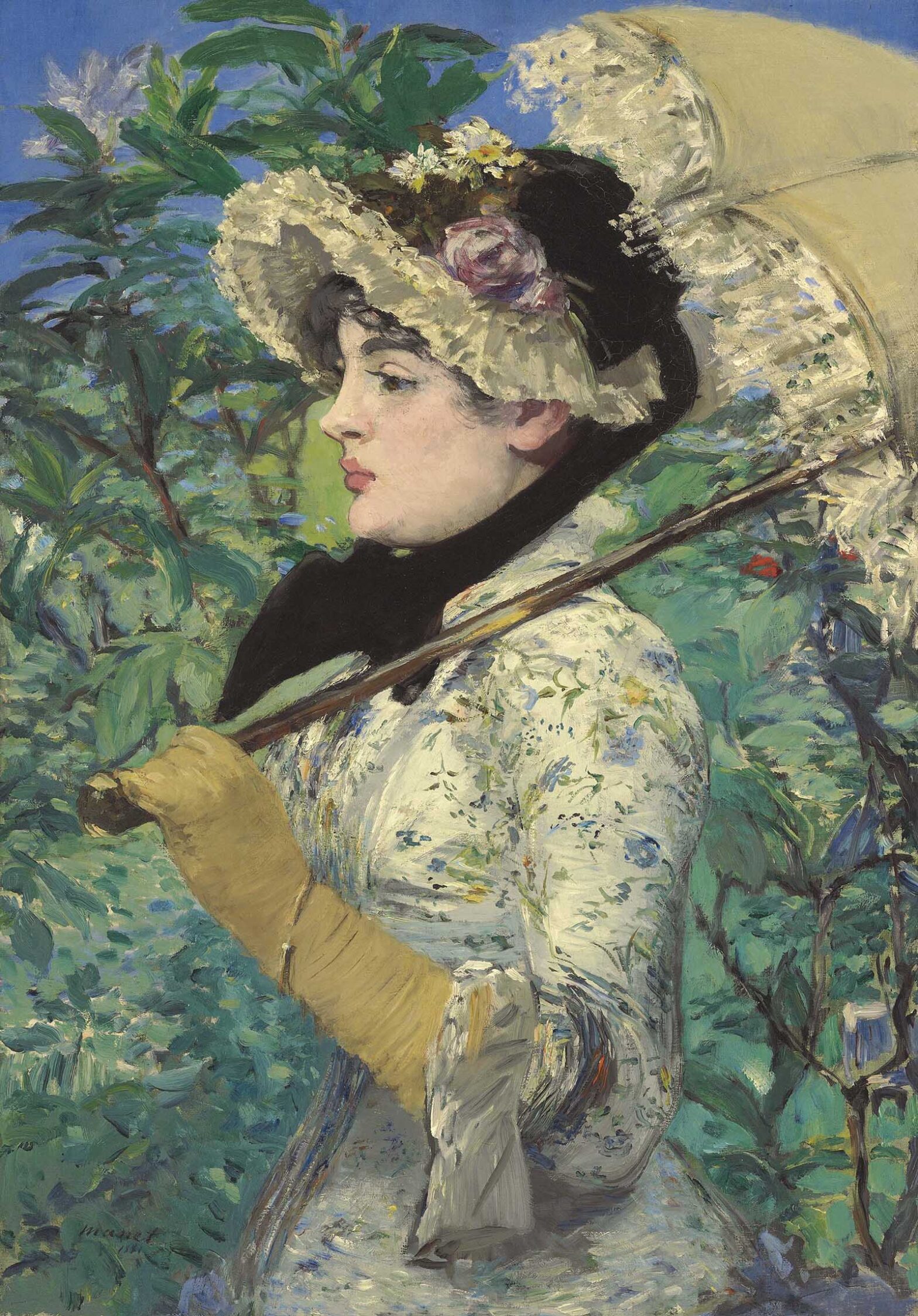 Side view of a woman in a white flowered dress, tan gloves, and frilly hat, holding a tan and lace parasol, with a greenery-filled background.