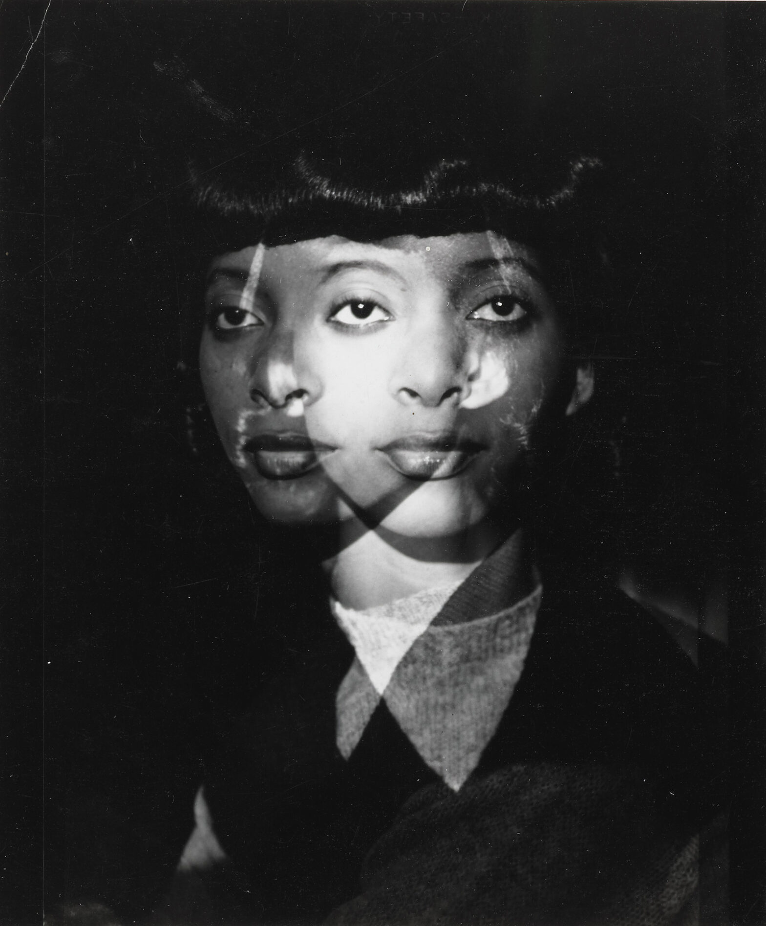 Double exposure of a Black woman both face front and face one quarter turned to the left.