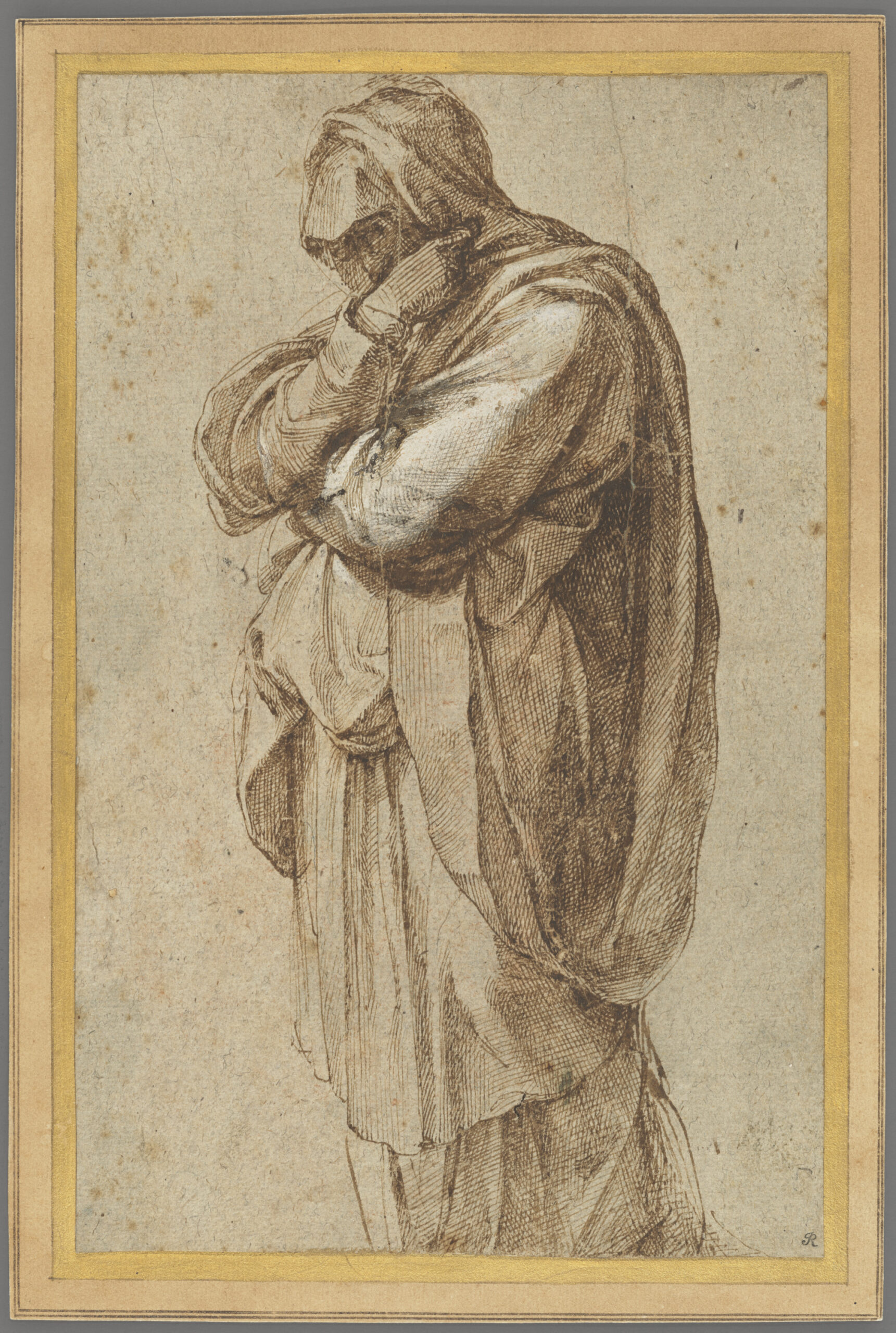 Figure of a woman in mourning wearing a full-length robe and arms wrapped around herself, concealing half of her face.