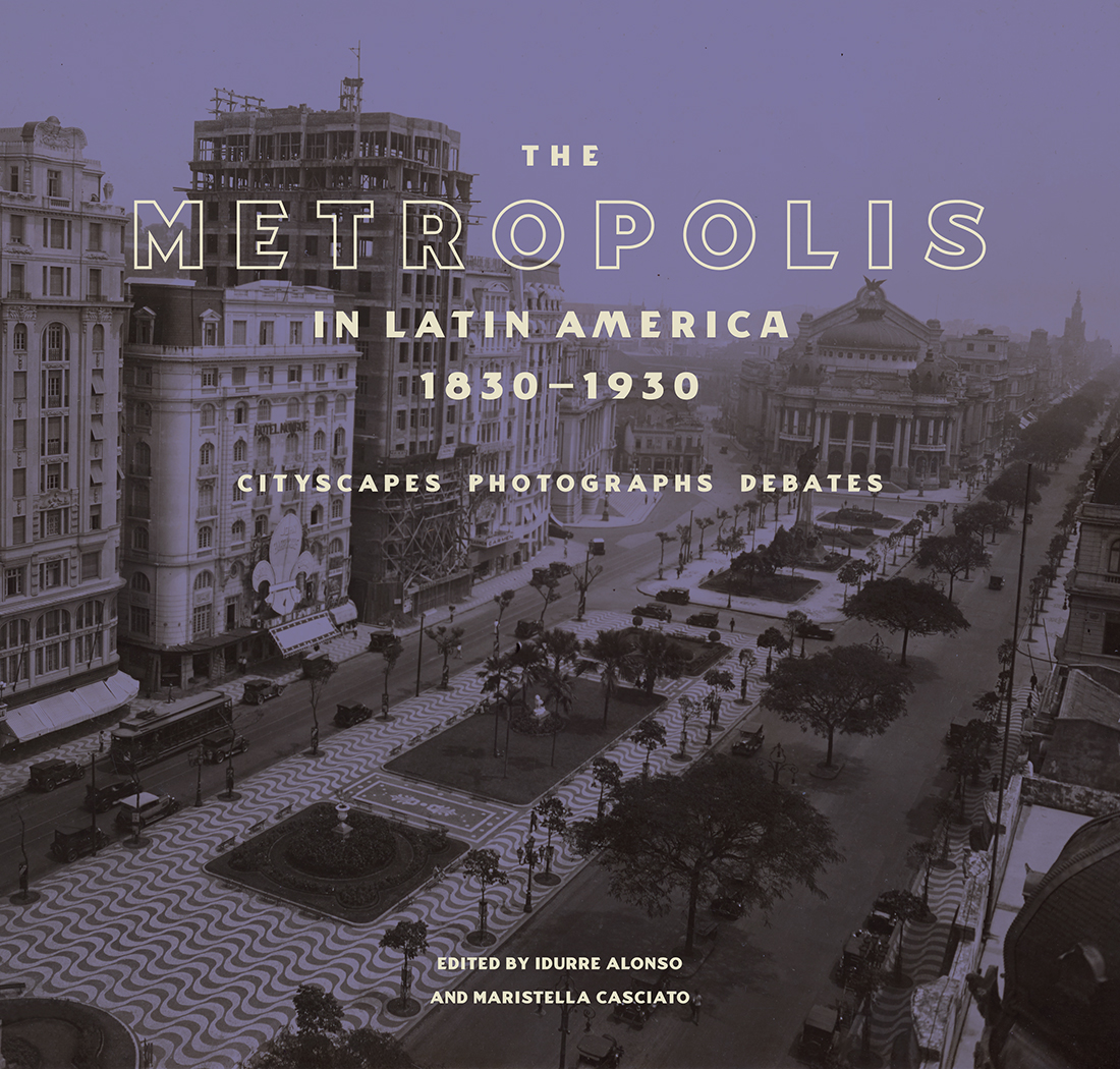 Book cover showing a black and white image of a city with a blue cast laid over it. Title of the book is printed over the image and reads The Metropolis in Latin America, 1830-1930: Cityscapes, Photographs, Debates