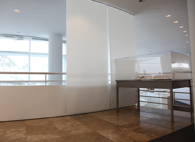 Display case of Gordon Matta-Clark materials at the Getty Research Institute framed against the sky
