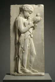 A Greek Marble Relief of a Young Girl Holding Doves