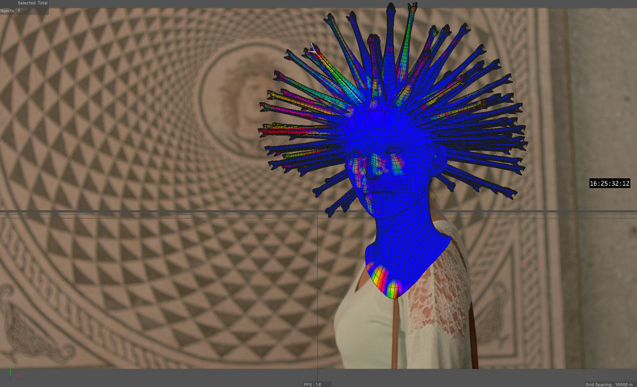 The grid and snakes over the actress's head now appear bright blue with rainbow highlights.