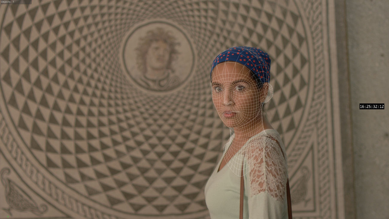 A woman with a spotted cap covering her hair stands in front of a mosaic. A grid maps the shape of her face.