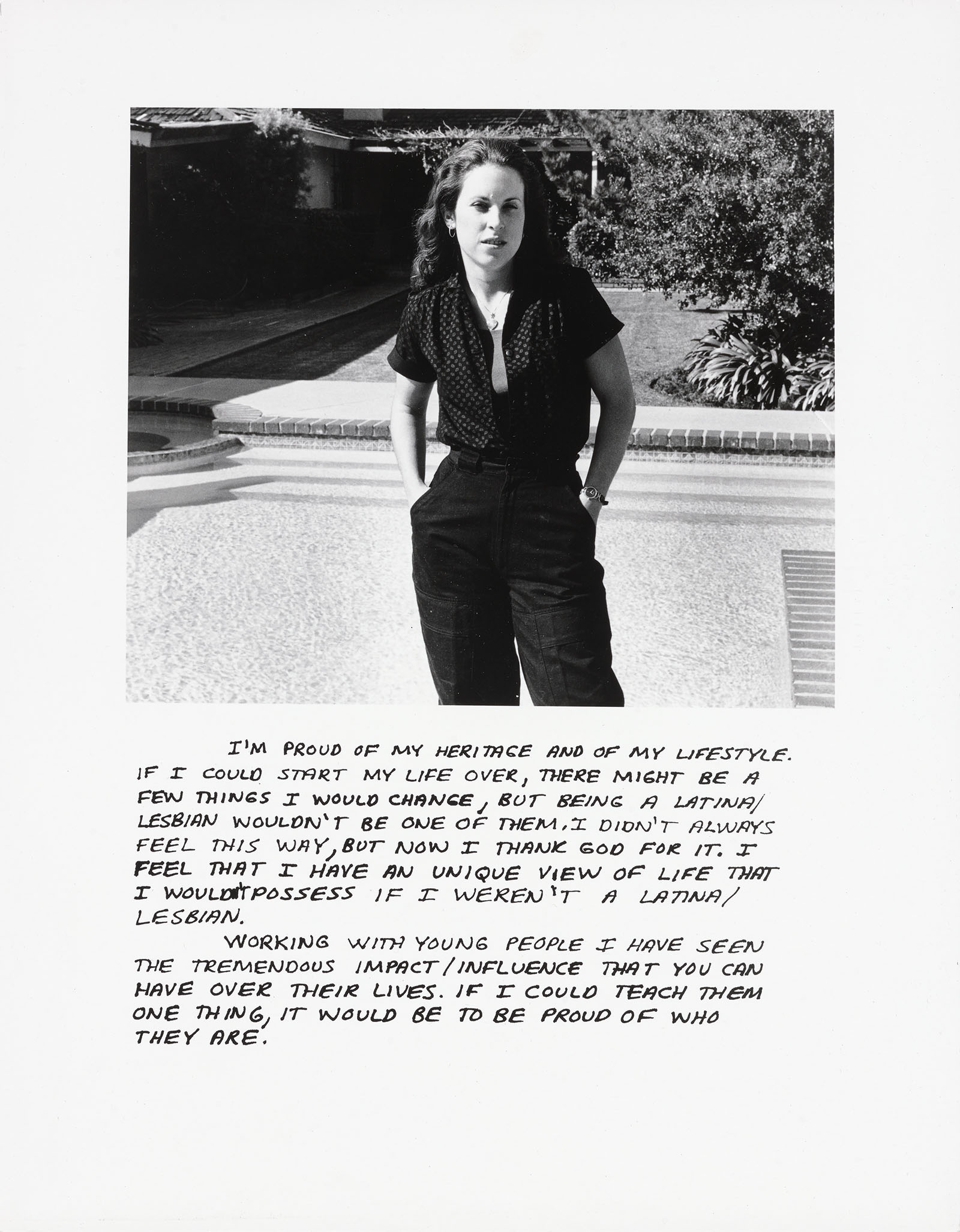 A woman in a jumpsuit standing in front of a pool.