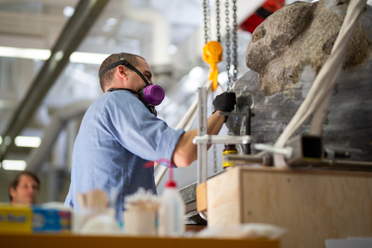 Erik cleans the surface of the rock with a tiny q-tip.