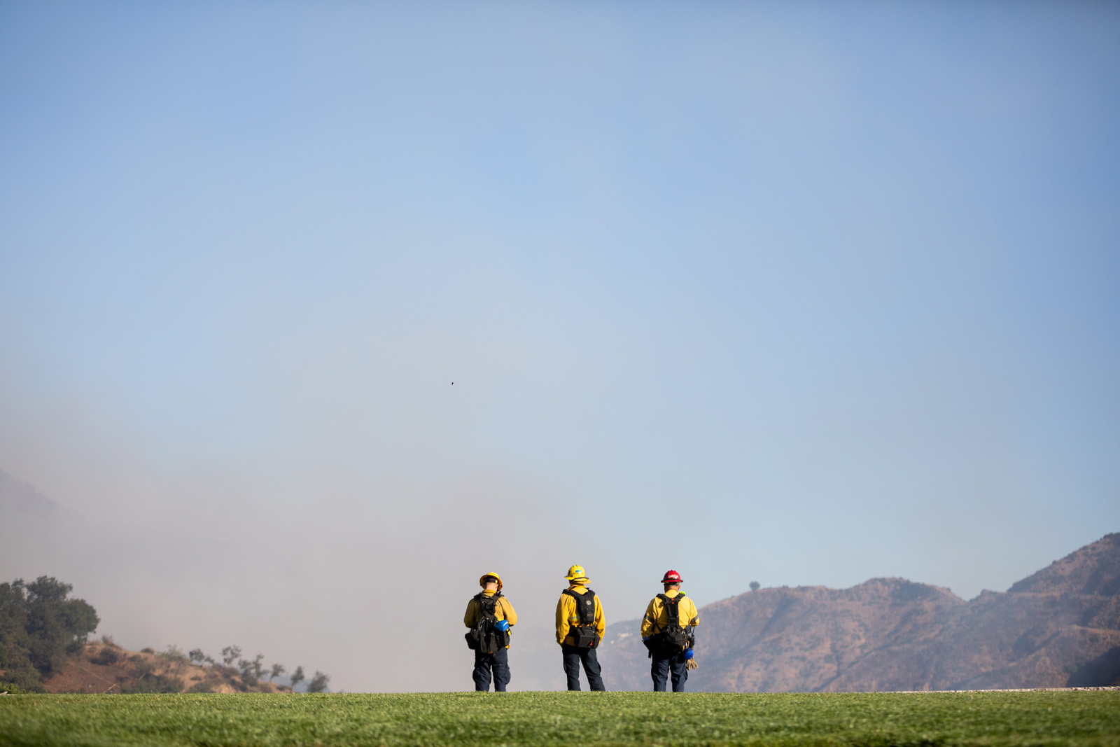 Firefighters stand at the perimeter of the Getty Center's helipad on Monday, coordinating response to flames at the Getty's northern edge. Firefighters stand at the perimeter of the Getty Center's helipad on Monday, coordinating response to flames at the Getty's northern edge.