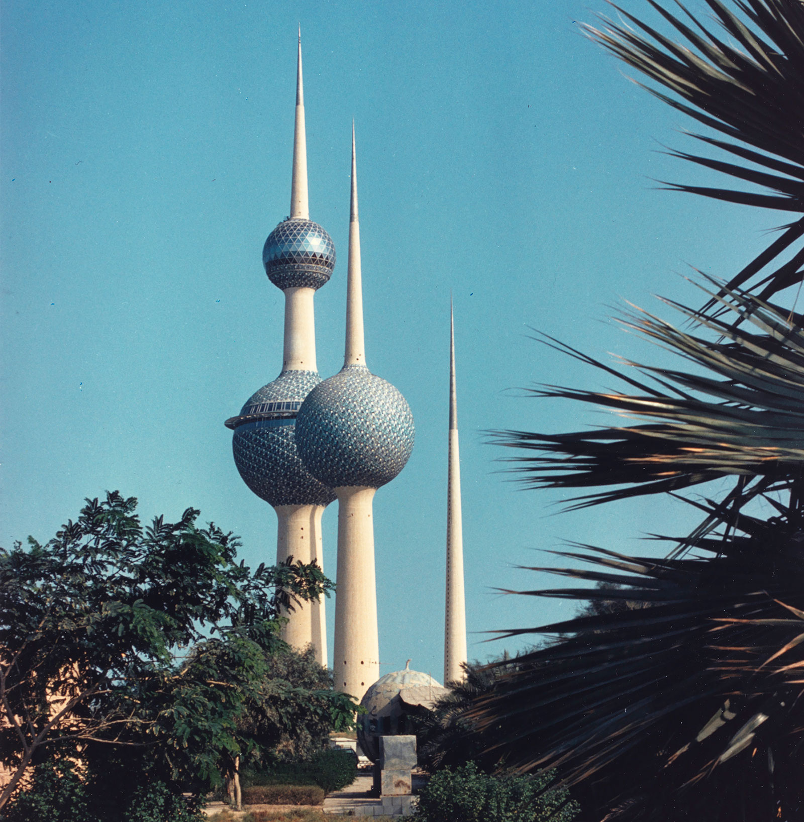 Tall, pointy white spires with blue spheres against a blue sky