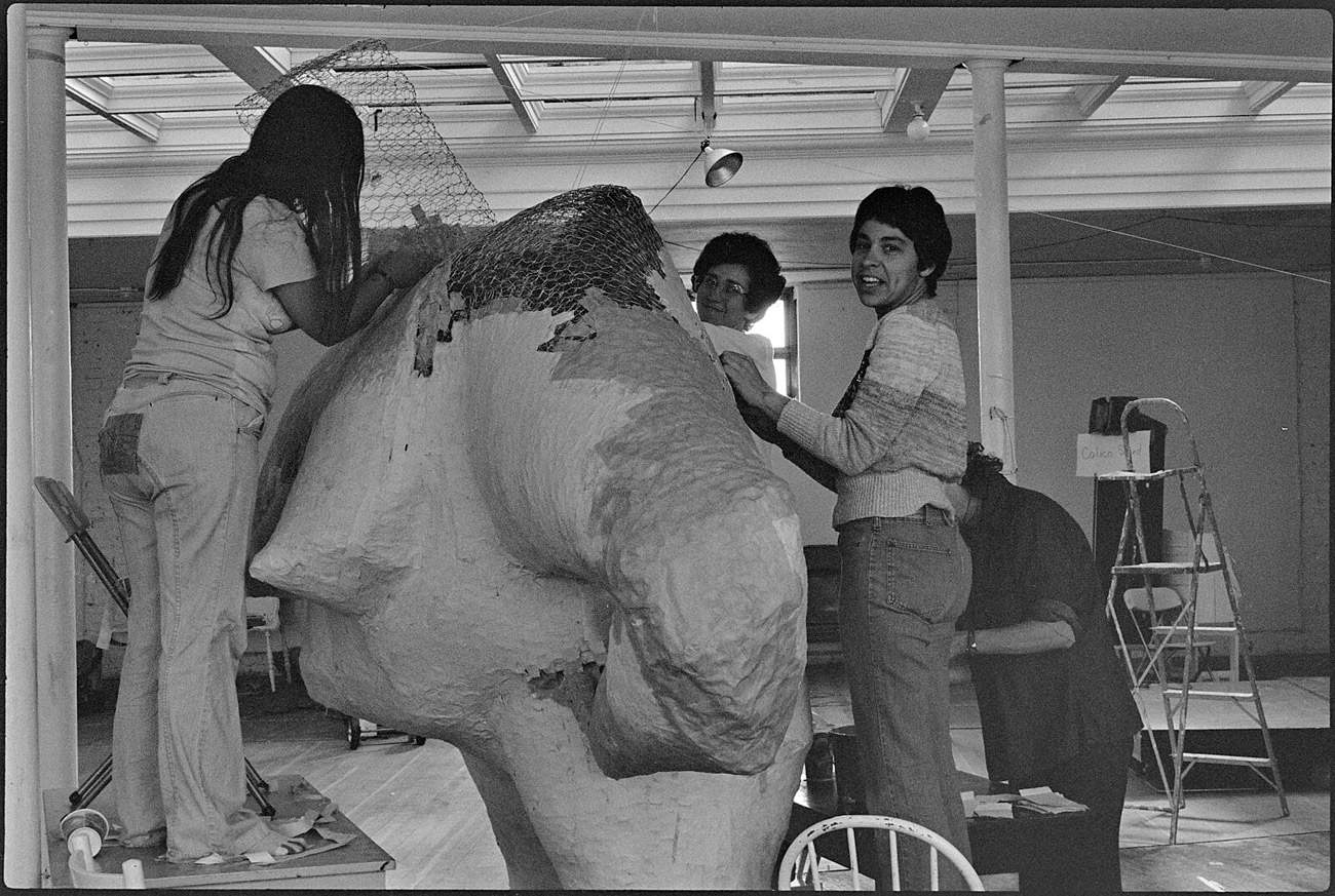 Four women work on body of large sculpture