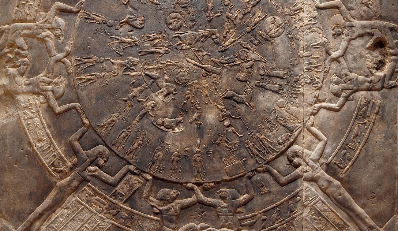 sculptural relief of figures holding hands around a circle