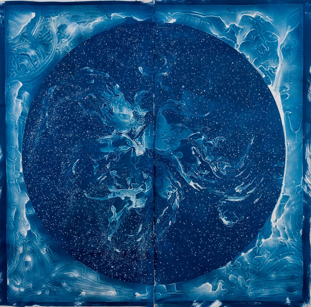 Dark blue circle with lighter blue cloud-like design in the center and a similar lighter blue nebula design outside the circle