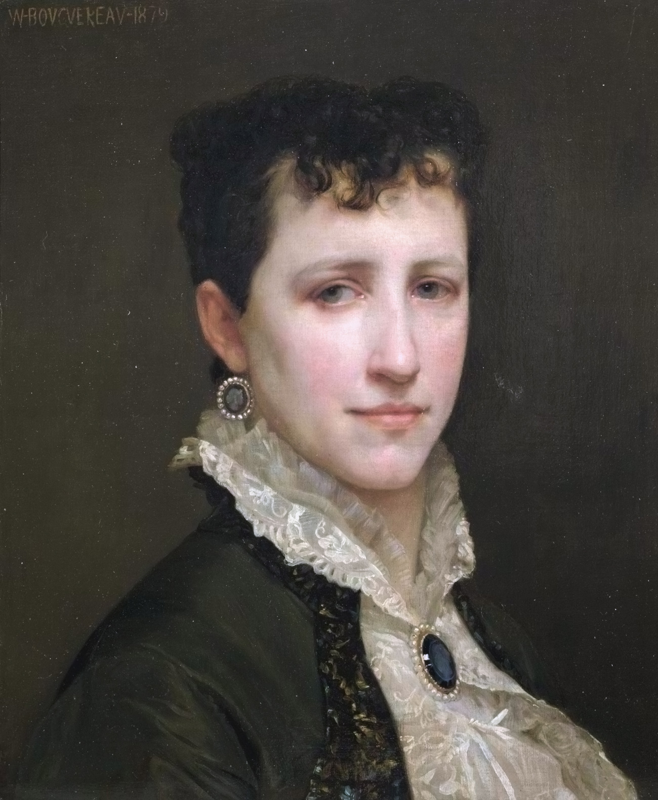 portrait of a woman in a frilly white shirt with a blue gem
