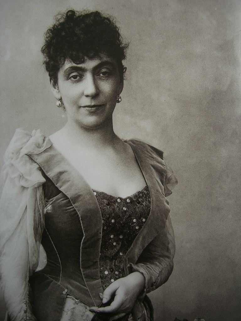 woman wearing fancy dress looks at the camera