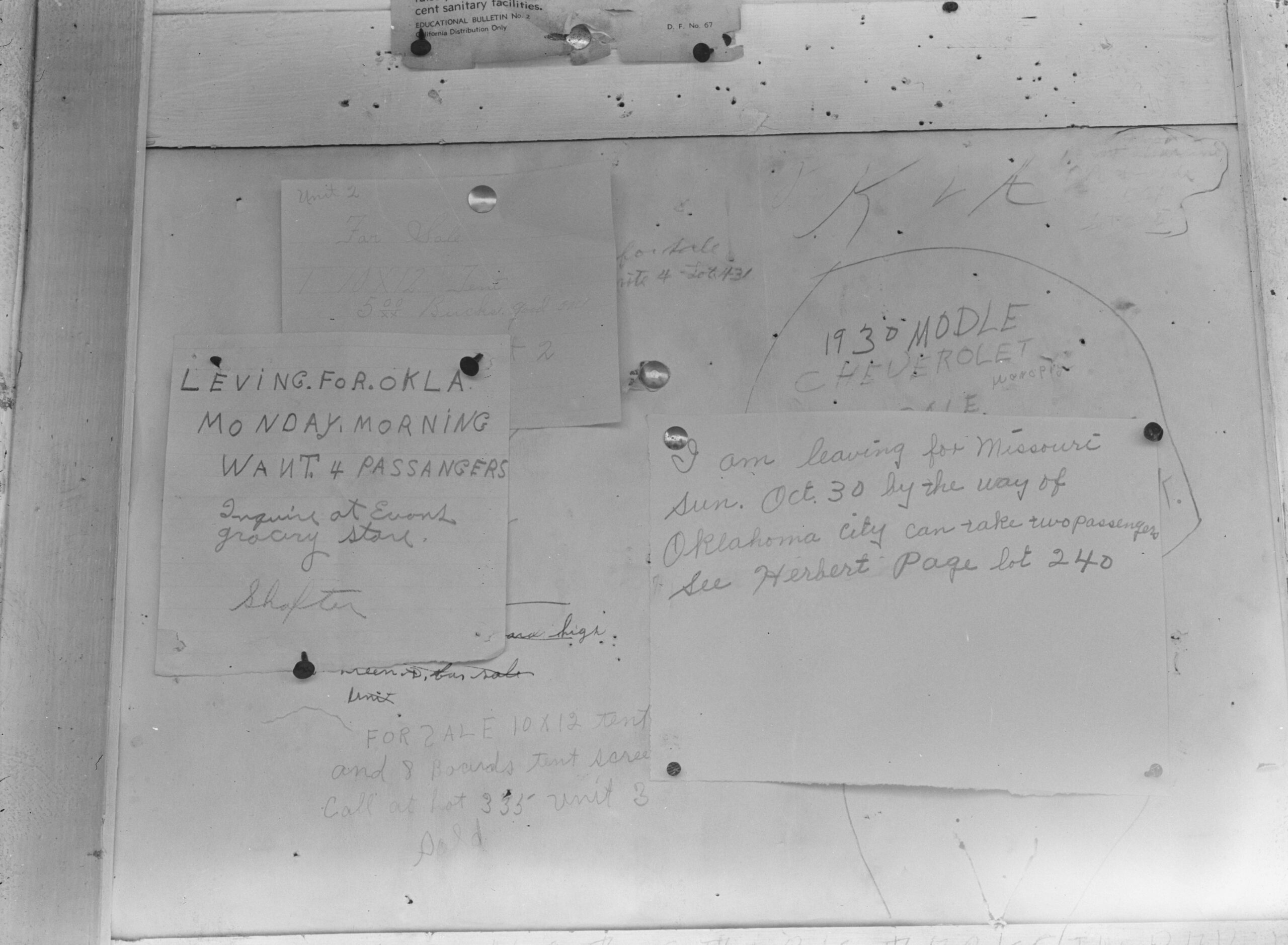 <em>Bulletin board in Shafter migrant camp, California. Many become discouraged, see no hope or future in California and return to their home states</em>, 1938, Dorothea Lange. Digital file from original negative. Library of Congress, Prints & Photographs Division, FSA/OWI Collection, LC-DIG-fsa-8b32661 black and white photograph of notes on a bulletin board