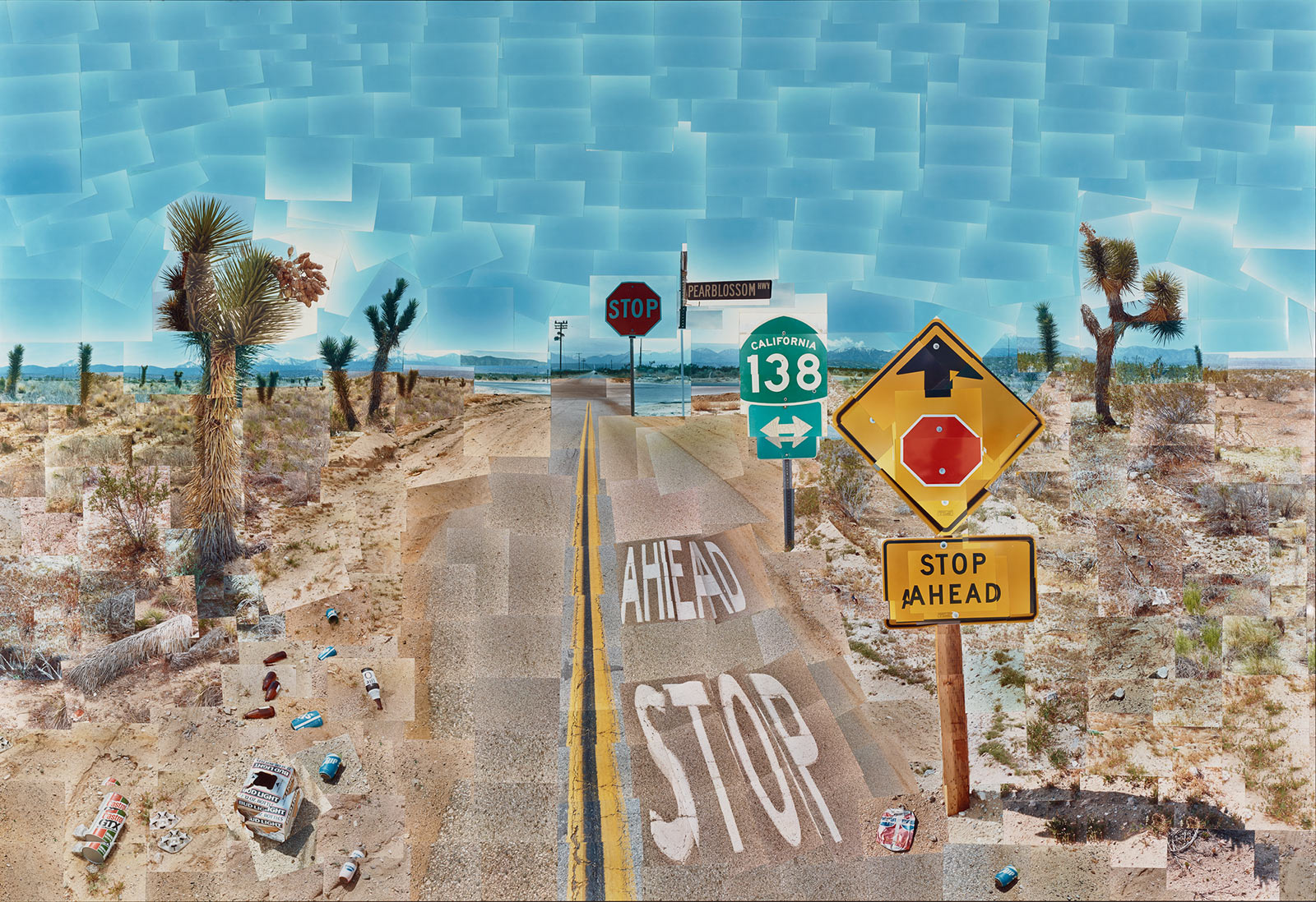 Image of desert road with stop signs and road signs, made up of smaller rectangle-shaped images so the overall image looks like a mosaic