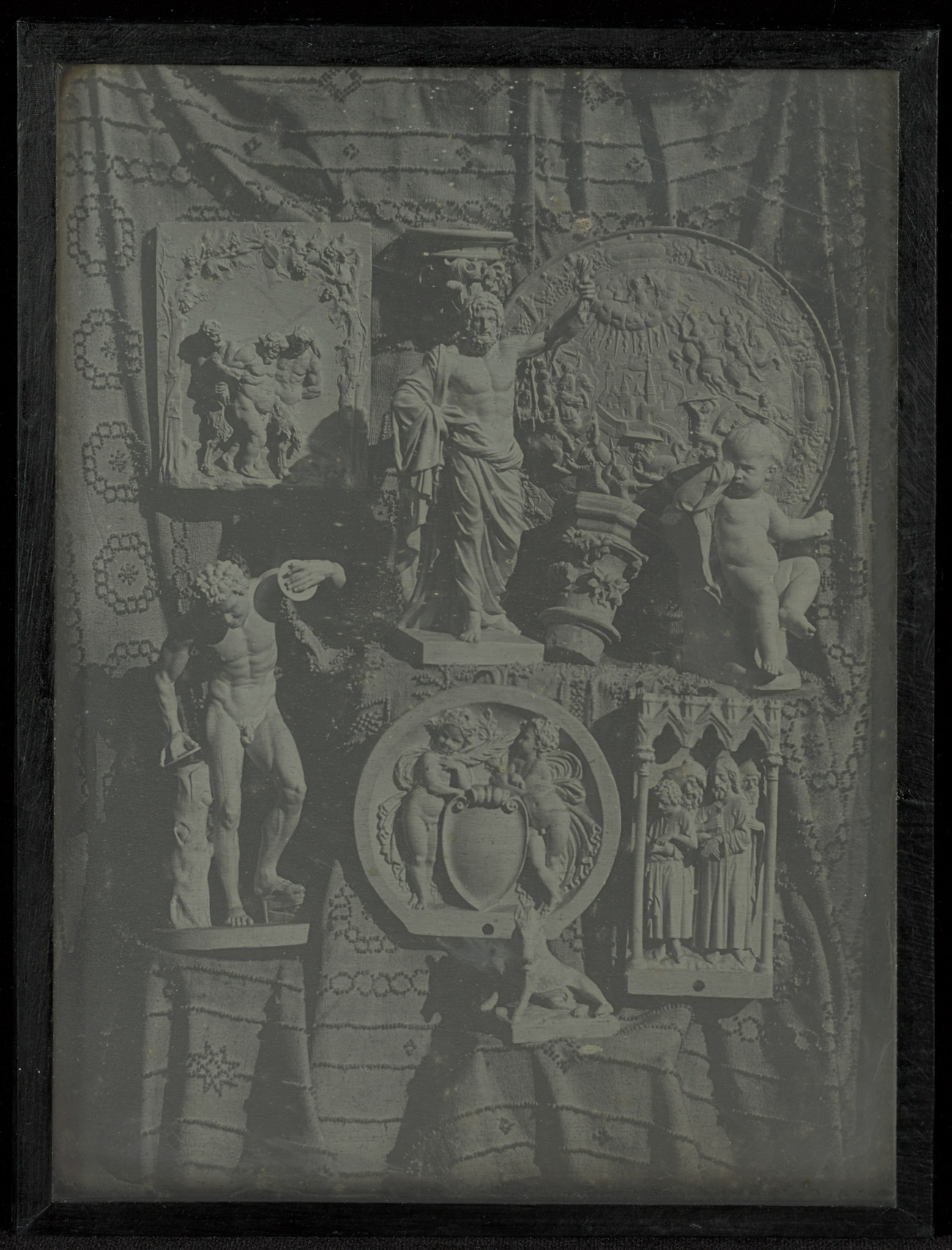 Daguerreotype of plaster casts depicting Greek figures, each placed on platforms that are covered with fabric