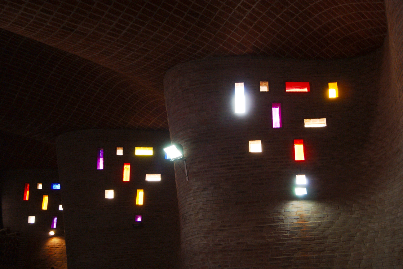 Interior view of Cristo Obrero with multi colored lights shining through the windows