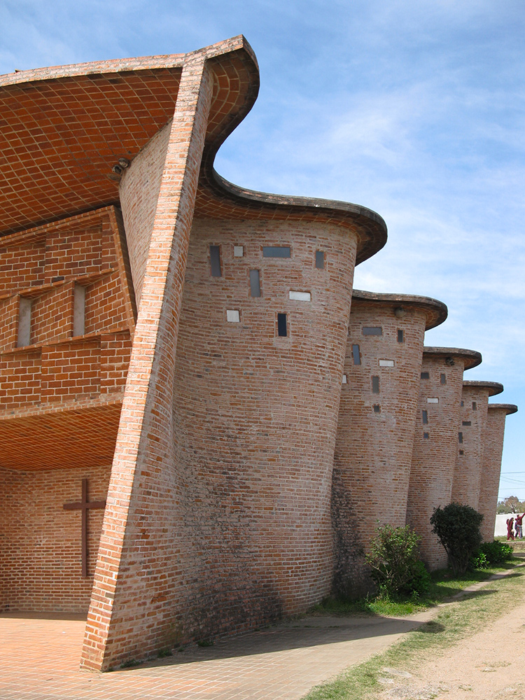The curved brick walls of the Cristo Obrero church