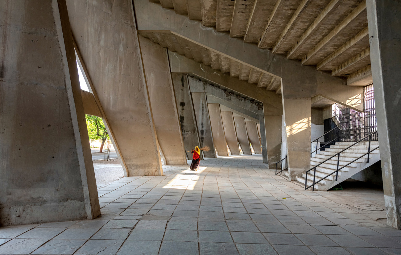 Concourse of stadium, with concrete columns holding up rows of seating