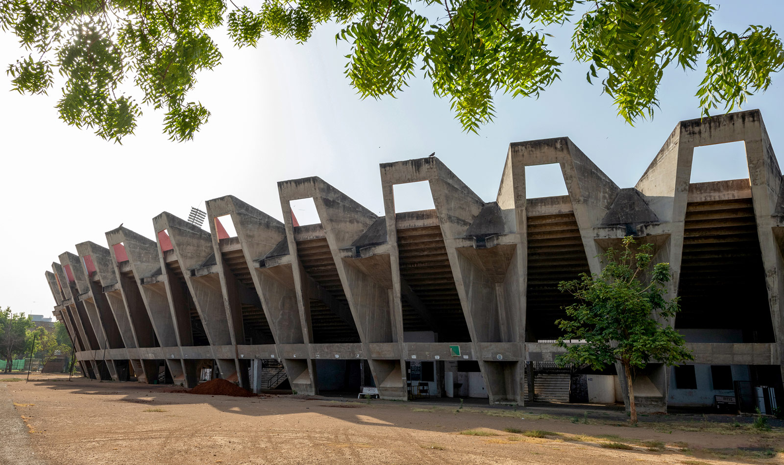 Exterior of stadium, with geometric concrete frame that creates trapezoidal shapes