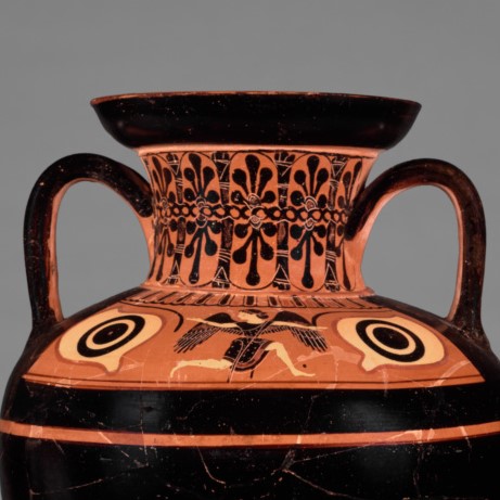A photograph of the top half of an amphora. A female figure with wings is painted under the neck.