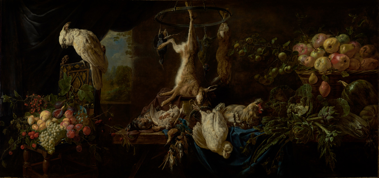 A table is filled with bowls of fruit and a selection of dead game birds, with a cockatoo perched above and a hare hanging on the wall.