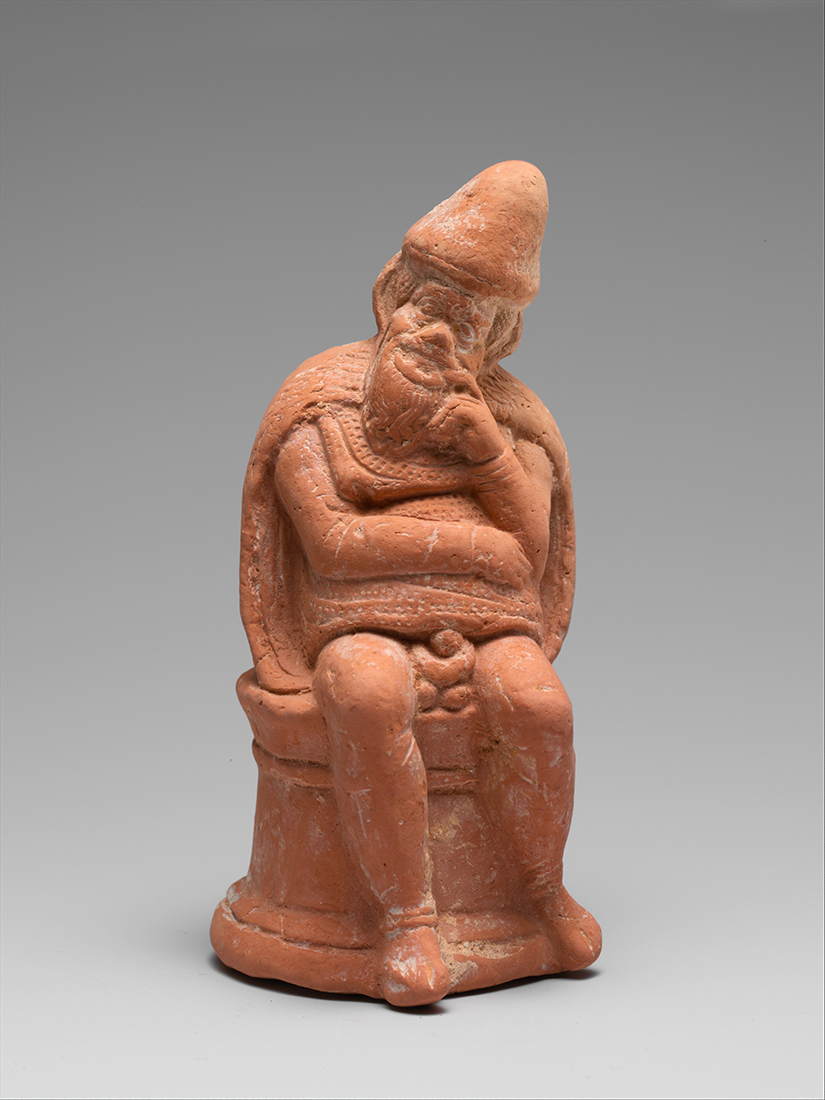 Terracotta statue of a man sitting on a short column, resting his chin on his hand in a thinking pose