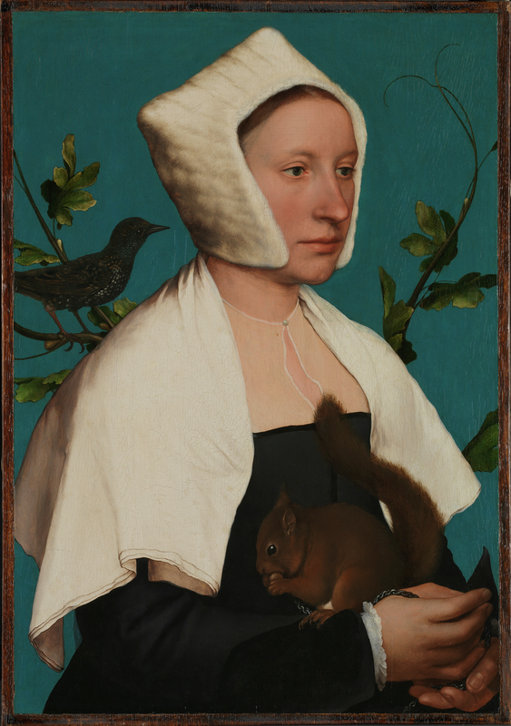 A young woman against a blue background dressed in a white cape and headdress, holding a squirrel on her right arm, with a starling perched attentively on her right shoulder