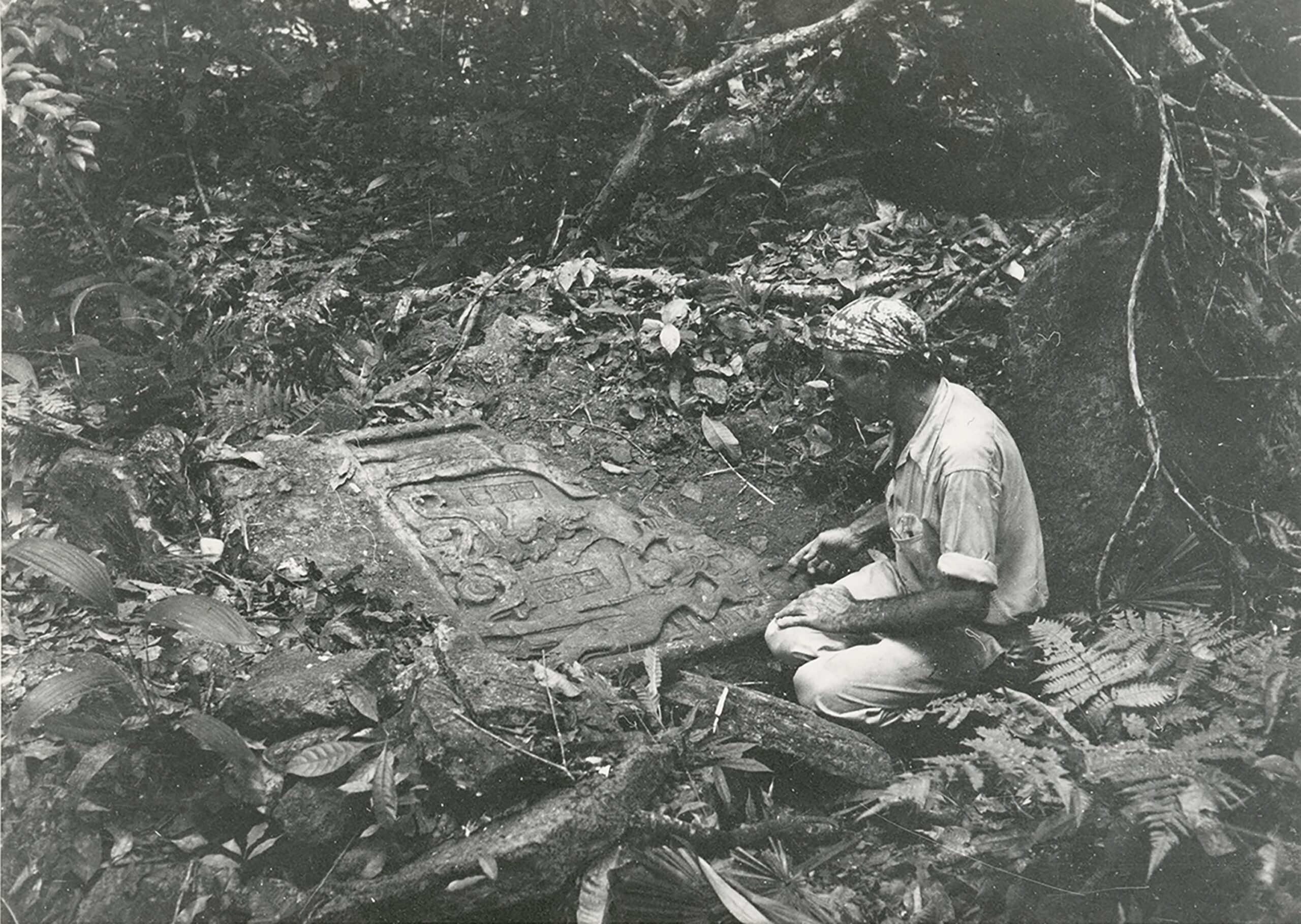 Dana Lamb with the bottom section of Laxtunich Lintel 1 April 1950. © New York, American Museum of Natural History. Photographer unknown. Black and white photograph of Dana Lamb, sitting on the ground next to the bottom section of Laxtunich Lintel 1.
