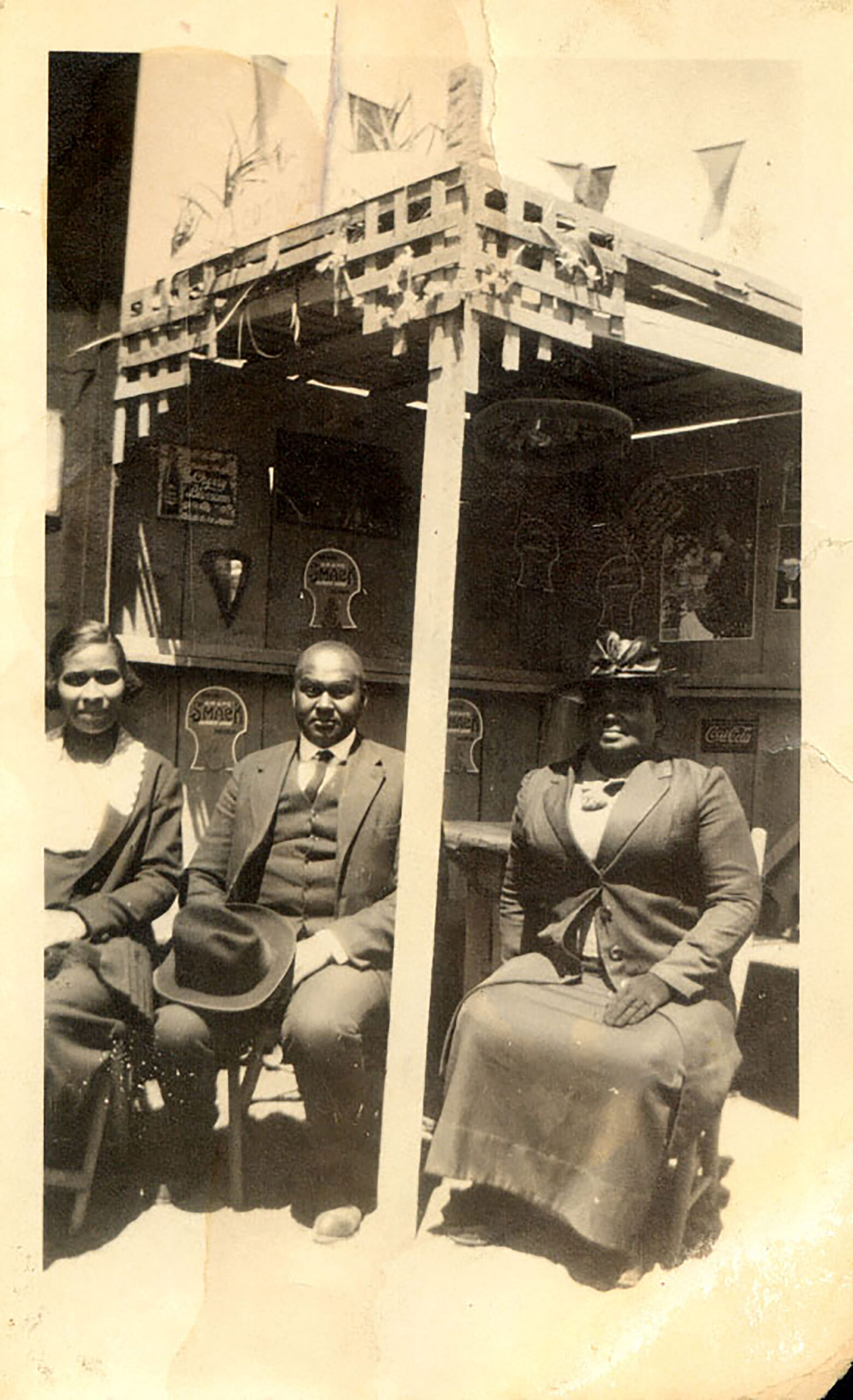From right to left: Mrs. Willa Bruce and her son, Harvey Bruce, with his wife, Meda, under a pop-up wooden tent structure that served as the early place of business for Bruce’s Lodge in Manhattan Beach, California, ca. 1912–20. Photo: Courtesy of the California African American Museum Photograph of African American family members Mrs. Willa Bruce and her son, Harvey Bruce, with his wife, Meda, under a pop-up wooden tent structure that served as the early place of business for Bruce’s Lodge in Manhattan Beach, California