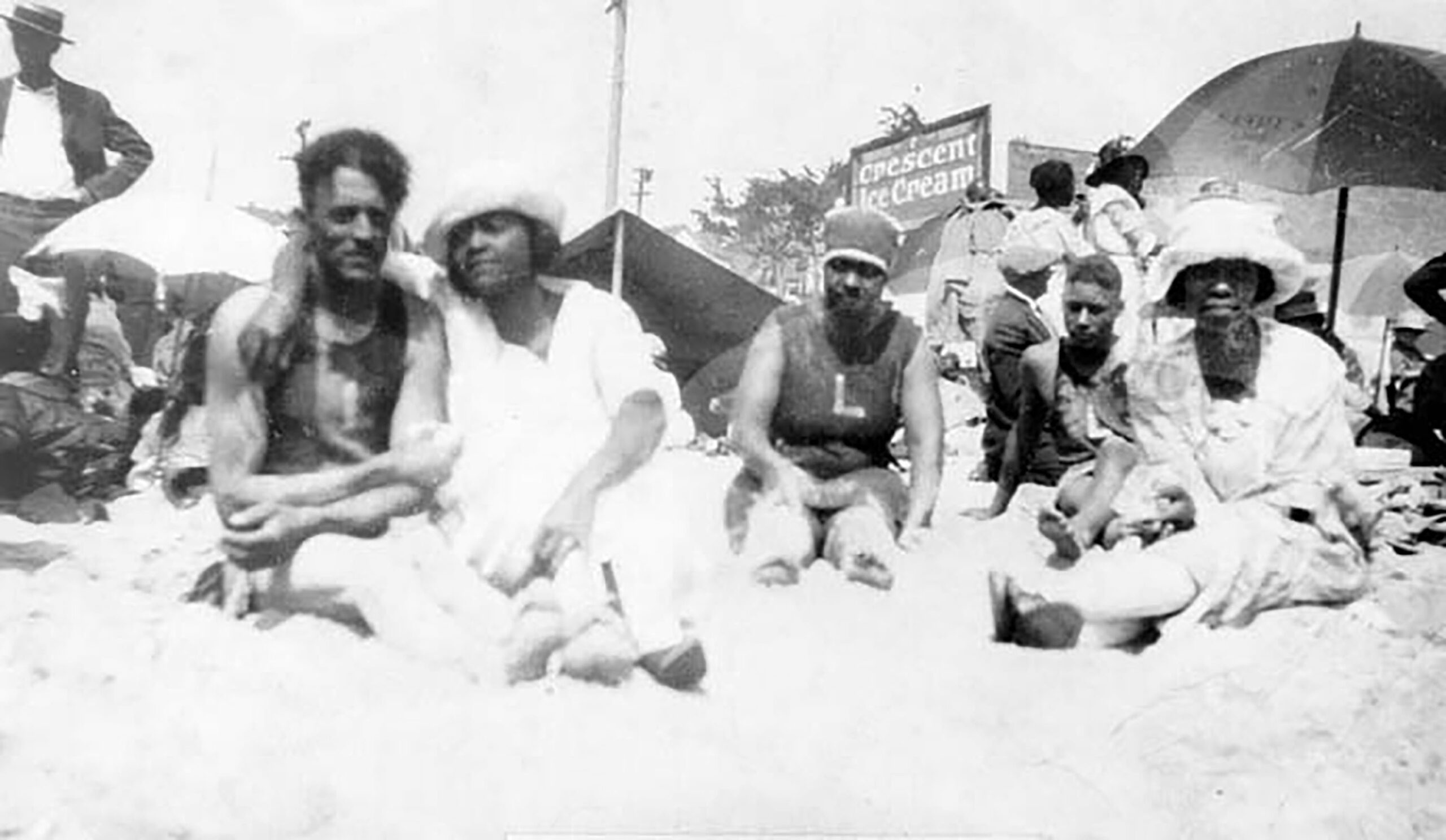 From left to right: Eddie DeQuir, Pearl Rozier DeQuir, Carolina Rozier Harrison, and Sarah Rozier Bryant, at the beach in Lake Elsinore, California, ca. 1921. Photo: From Shades of L.A. Collection, Los Angeles Public Library Black and white photo of African American family group at the beach in Lake Elsinore, California, ca. 1921