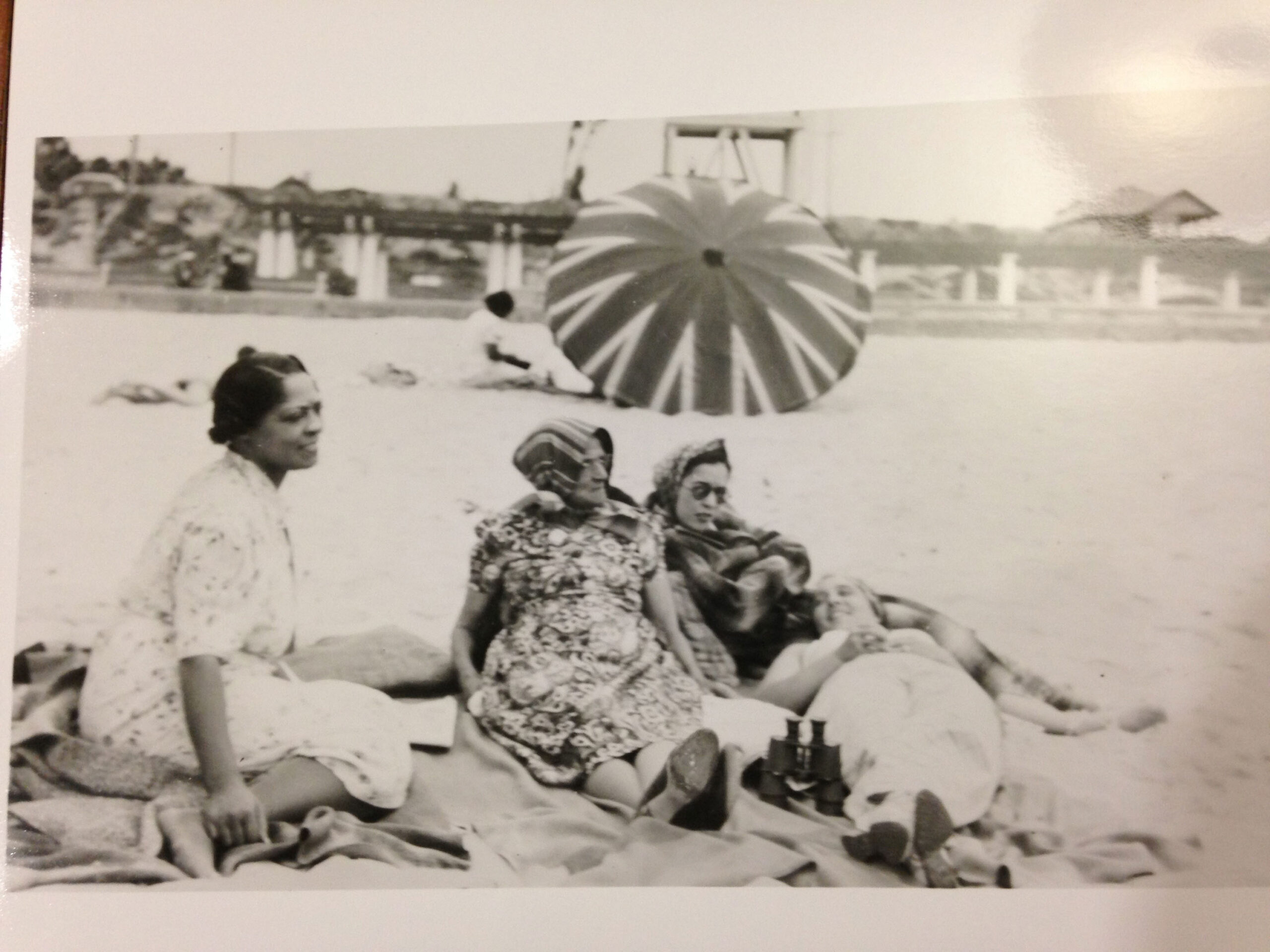 Undated photograph showing the women of the Cunningham family at the Bay Street Beach. This is the area of the Santa Monica beach that became most associated with African American beach use after the Casa Del Mar Club was opened in 1924. Photo: Mariam Matthews Collection, University of California Library Special Collections Old photo of three African American women lounging on the beach together