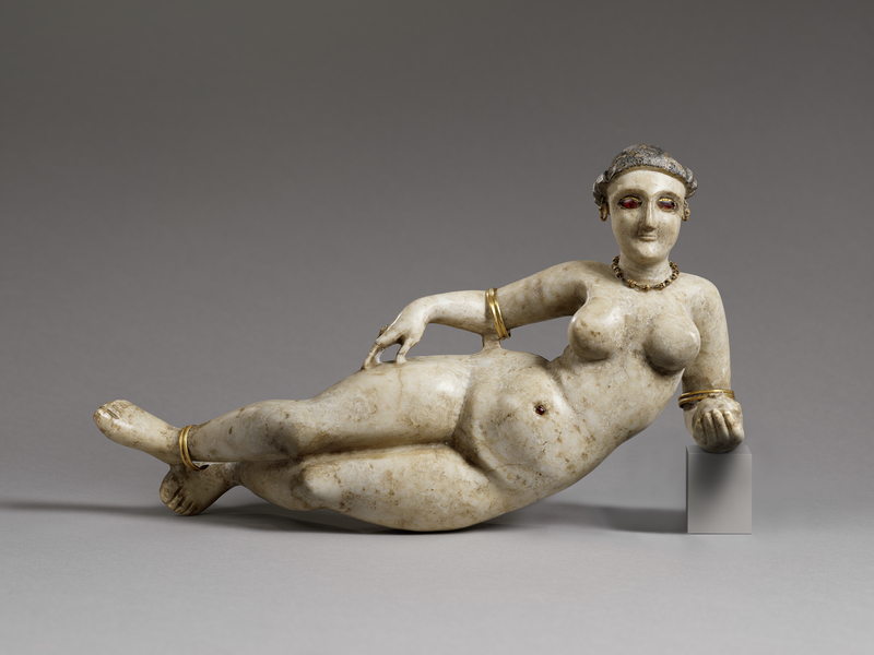 Reclining Goddess, 2nd–1st century B.C., Parthian. Alabaster, 6 13/16 × 13 × 3 9/16 in. The Wyvern Collection Carved stone nude female figure reclining on her side. She has garnet eyes and a belly button and has gold jewelry.